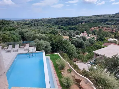 an image of a swimming pool in a villa at Villa Olive Valley in Loutrákion
