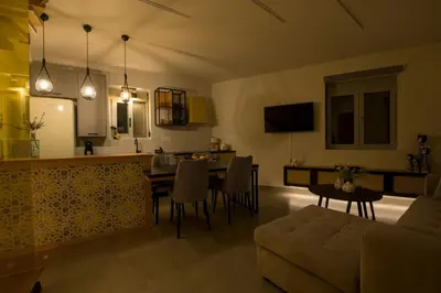 a kitchen and living room with a table and chairs at Casa Di Camomilla in countryside in Chania Town