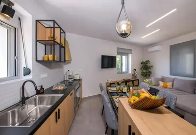 a kitchen and living room with a sink and a couch at Casa Di Camomilla in countryside in Chania Town
