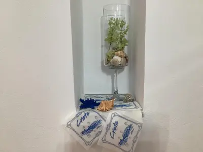 a table with two blue and white plates and a vase at Landro House in Kissamos