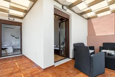 a room with chairs and a table in a room at Villa Nektar with private ecologic pool and amazing view! in Kondópoula
