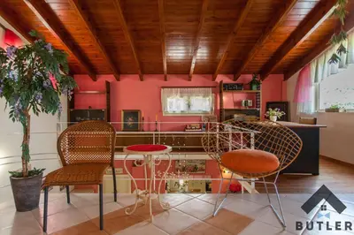 a room with pink walls and chairs and a table at Eco Friendly Country Home in Kókkinos Pírgos