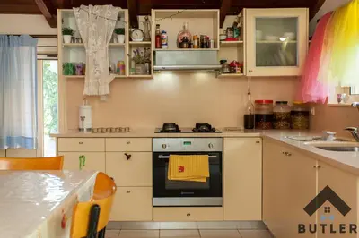 a kitchen with white cabinets and an oven at Eco Friendly Country Home in Kókkinos Pírgos