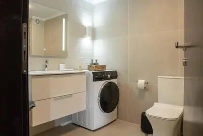 a bathroom with a washing machine and a toilet at Sfakion 6 apartment in Chania Town