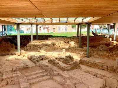 a building under a wooden roof with rocks at Canevaro Twins (North) in Chania Town