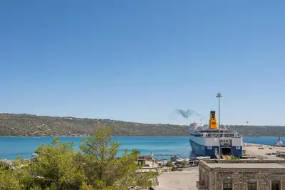 a large boat is docked in a body of water at Nidus President in Souda
