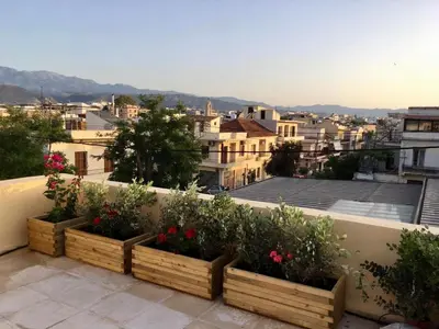 a balcony with three wooden planters filled with flowers at Canevaro Twins (South) in Chania Town