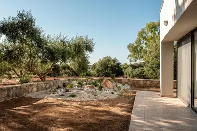 a view of a garden from the entrance of a house at Efrossini Suites in Kounoupidhianá