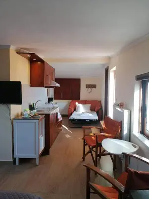 a kitchen and living room with a couch and a table at Casa Ag.Apo in Daratso