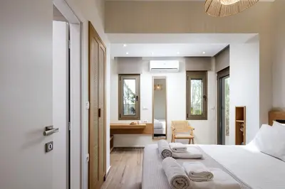 a bedroom with a bed with towels on it at Quiet Villa Aviana,garden, heated pool,BBQ,jacuzzi in Gerani Chanion