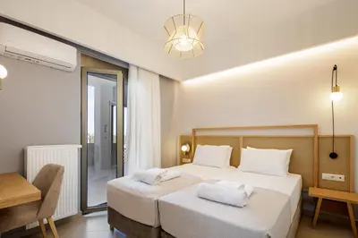 a bedroom with a bed and a table and a chair at Quiet Villa Aviana,garden, heated pool,BBQ,jacuzzi in Gerani Chanion