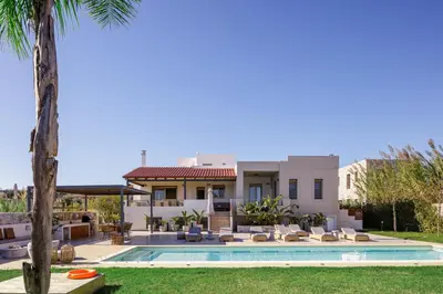 a villa with a swimming pool and palm trees at Quiet Villa Aviana,garden, heated pool,BBQ,jacuzzi in Gerani Chanion