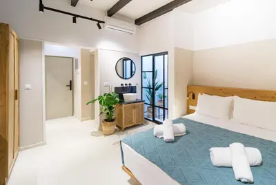 a bedroom with a bed with two pillows at Incentra in Chania Town