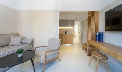 a living room with a couch and a table and chairs at Incentra in Chania Town