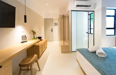 a bedroom with a bed and a desk and a sink at Incentra in Chania Town