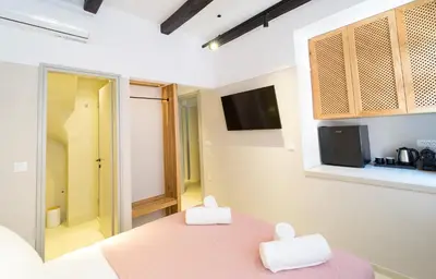 a room with a pink table with two white towels at Incentra in Chania Town