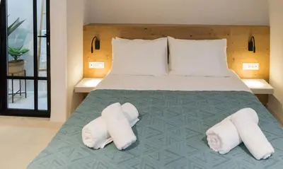 a bedroom with a bed with white towels on it at Incentra in Chania Town