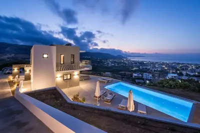 a villa with a swimming pool at night at Villa Thea, stunning view, pool, BBQ, Brand new. in Kissamos