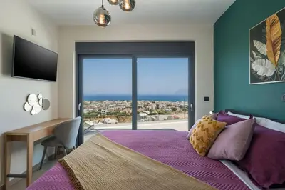 a bedroom with a bed and a large window at Villa Thea, stunning view, pool, BBQ, Brand new. in Kissamos