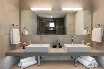 a bathroom with two sinks and a large mirror at Villa Thea, stunning view, pool, BBQ, Brand new. in Kissamos