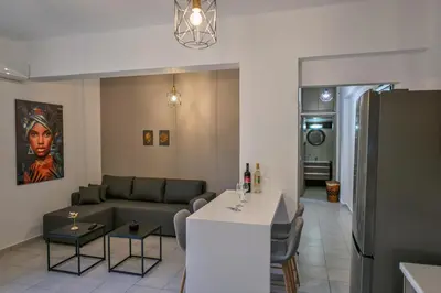 a living room with a couch and a table at Artemis No1 Apartment in Kissamos