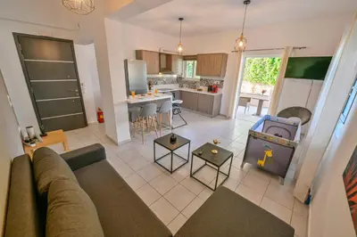 a living room with a couch and a kitchen at Artemis No1 Apartment in Kissamos