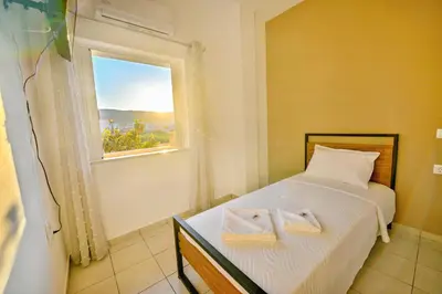 a bedroom with a bed with two towels on it at Artemis No1 Apartment in Kissamos