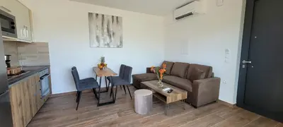 a living room with a couch and a table at Splendid Villas and Family Resort in Kalamitsi Amygdali