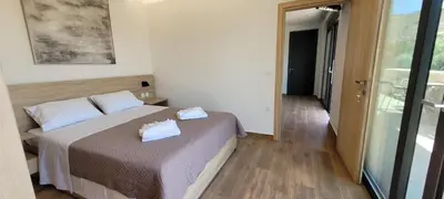 a bedroom with a bed with two pillows on it at Splendid Villas and Family Resort in Kalamitsi Amygdali