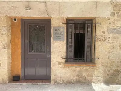 a door of a building with a sign next to it at Hippie City Hostel in Chania Town