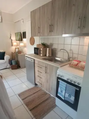 a kitchen with a sink and a stove at Kaldora Apartment in Chania Town