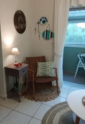a living room with a chair and a table at Kaldora Apartment in Chania Town
