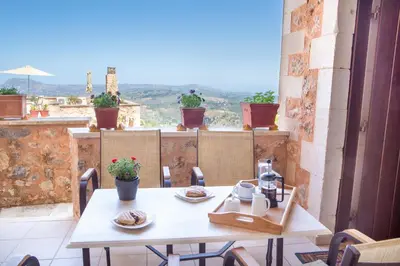 a table and chairs on a balcony with a view at Samonas - Red villa Fliskouni in Chania Town