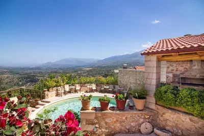 a villa with a swimming pool and a house at Samonas - Red villa Fliskouni in Chania Town