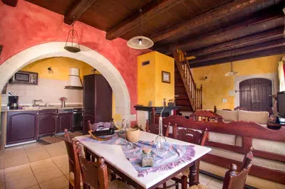 a kitchen with a table and chairs in a room at Samonas - Red villa Fliskouni in Chania Town