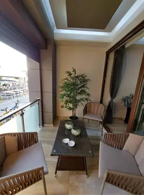 a living room with a table and a potted plant at Rika’s Luxury seaside apartment in Chania Town