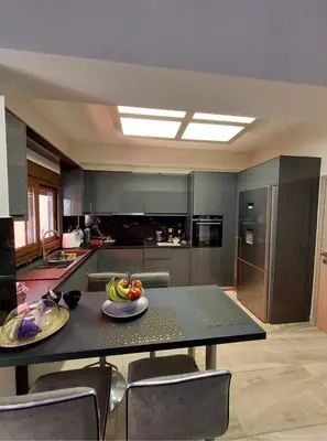 a kitchen with a table with a plate of fruit on it at Rika’s Luxury seaside apartment in Chania Town
