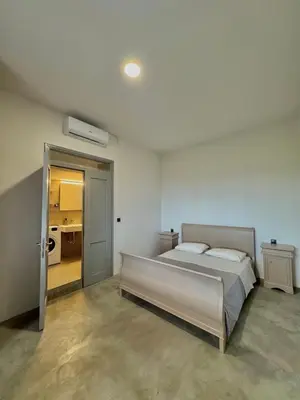 a bedroom with a bed and a door leading into a room at Remvi Suite in Chania in Xamoudhokhórion