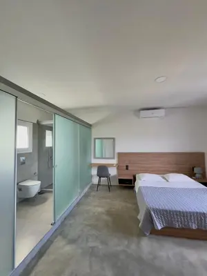 a bedroom with a bed and a tub in a room at Remvi Suite in Chania in Xamoudhokhórion