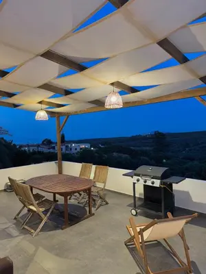 a patio with a table and chairs and a grill at Remvi Suite in Chania in Xamoudhokhórion
