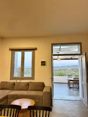 a living room with a couch and a balcony at Remvi Suite in Chania in Xamoudhokhórion