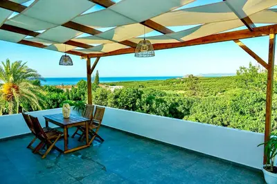 a patio with a table and chairs on a balcony at Remvi Suite in Chania in Xamoudhokhórion