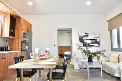 a kitchen and living room with a table and a couch at Remvi Suite in Chania in Xamoudhokhórion