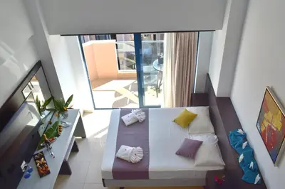 an overhead view of a room with a bed and a balcony at Galini Sea View Hotel in Agia Marina Nea Kydonias