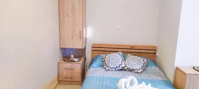a bedroom with a bed with a blue comforter at Shiny Luxe :) in Kissamos