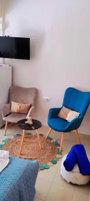 a living room with two chairs and a table at Shiny Luxe :) in Kissamos