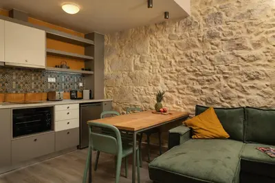 a kitchen and living room with a table and a couch at Dimitra Central Apts in Chania Town