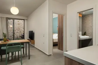 a kitchen and living room with a table and chairs at Dimitra Central Apts in Chania Town