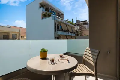 a small table and chairs on a balcony at Dimitra Central Apts in Chania Town