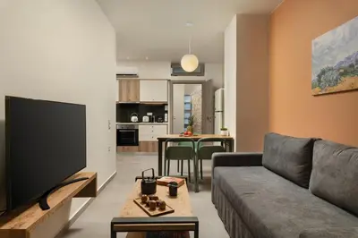 a living room with a couch and a tv at Dimitra Central Apts in Chania Town